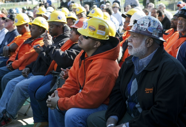 Construction workers listen as President Barack Obama delivers remarks at Georgetown Waterfront Park in Washington, D.C., regarding the infrastructure piece of the American Jobs Act, Nov. 2, 2011.